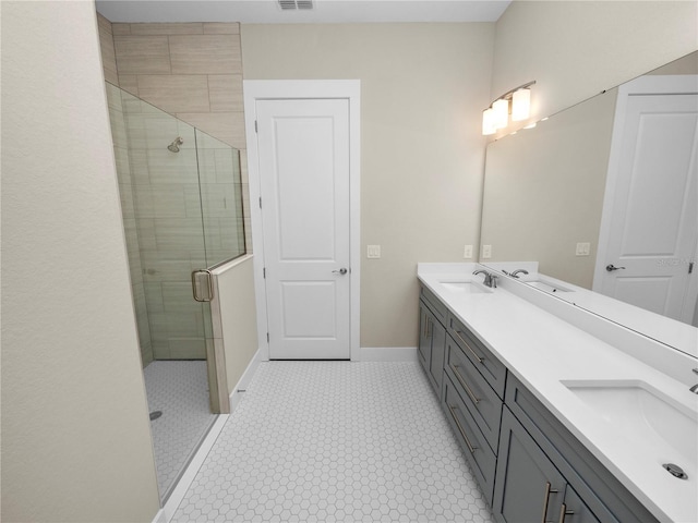 bathroom featuring a shower with door and vanity