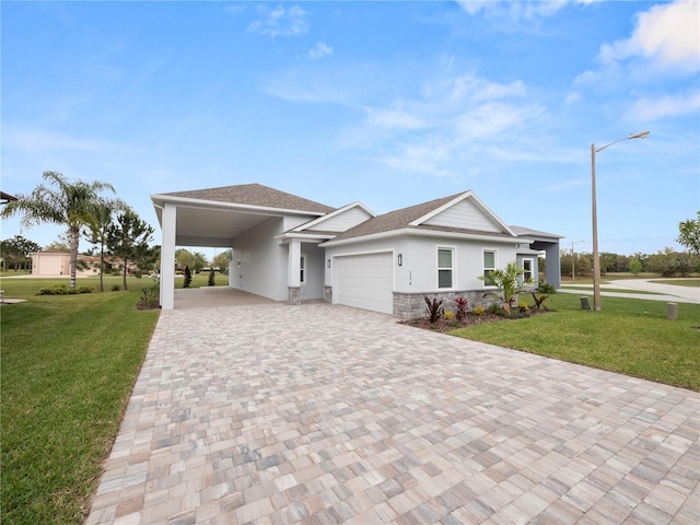 view of front facade with a front lawn, a garage, and a carport