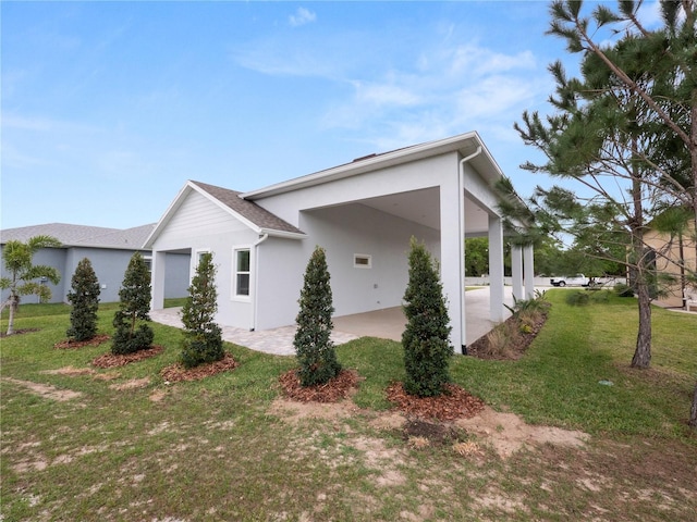 view of home's exterior with a carport and a lawn