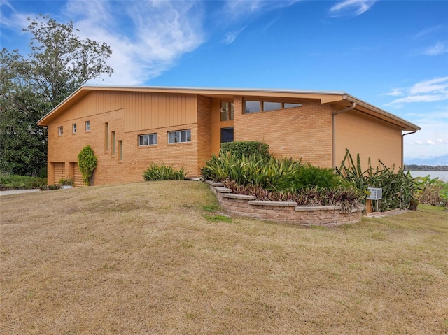 view of side of home with a lawn