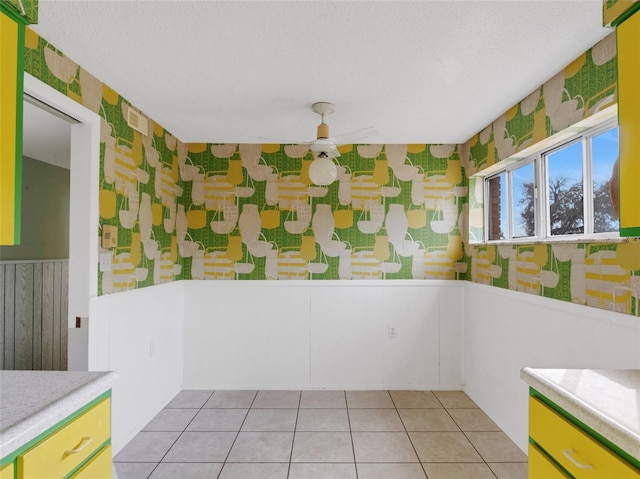 interior space featuring a textured ceiling and light tile patterned flooring