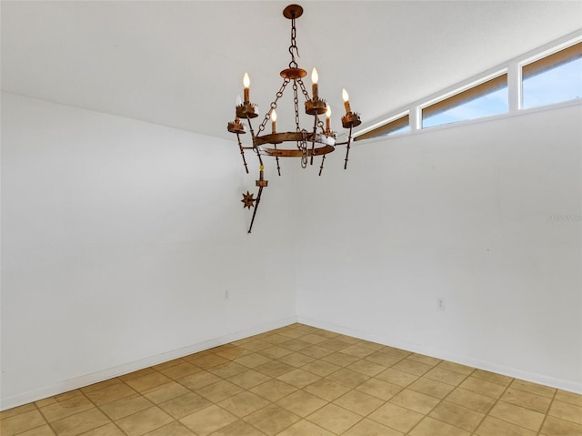 spare room with an inviting chandelier and lofted ceiling