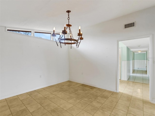 unfurnished dining area with an inviting chandelier, lofted ceiling, and light tile patterned floors