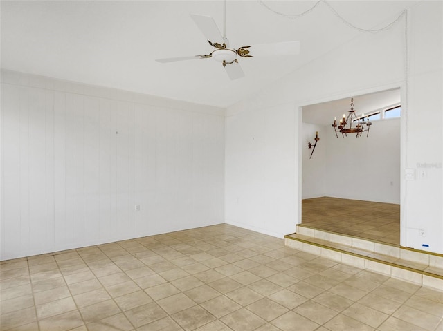 tiled empty room featuring lofted ceiling and ceiling fan with notable chandelier