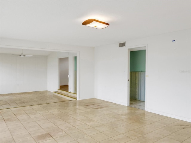 tiled empty room with ceiling fan