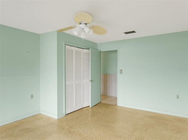 unfurnished bedroom featuring ceiling fan and a closet