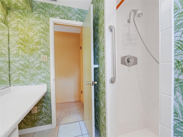 bathroom featuring tile patterned flooring and a tile shower