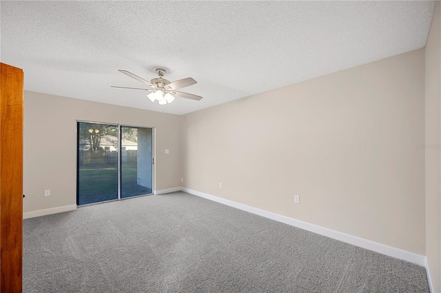 carpeted spare room with ceiling fan and a textured ceiling