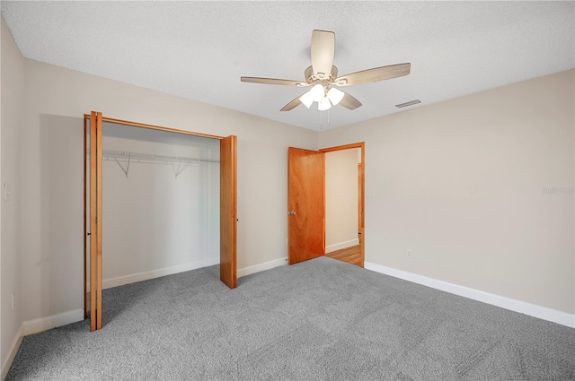 unfurnished bedroom featuring carpet floors, a closet, and ceiling fan