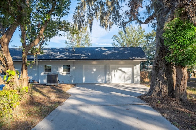 exterior space featuring a garage and central air condition unit