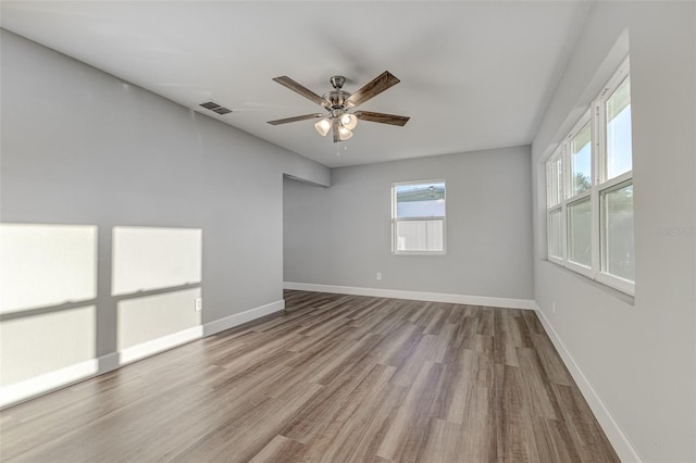 empty room with light hardwood / wood-style flooring and ceiling fan