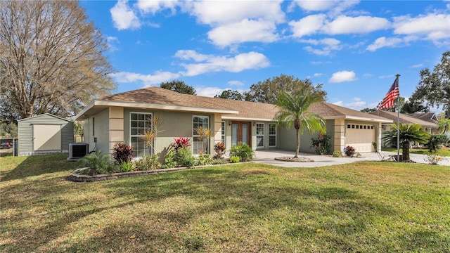 ranch-style house with a garage, a front lawn, and central air condition unit