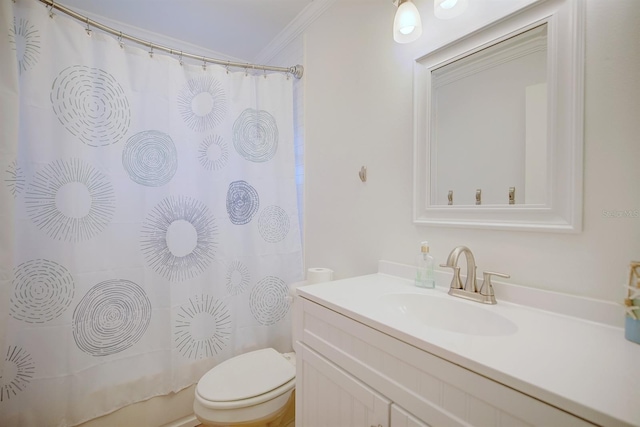 bathroom with vanity, crown molding, and toilet