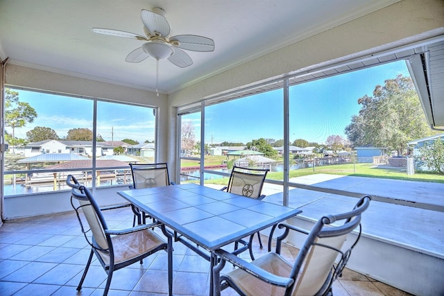 sunroom / solarium featuring ceiling fan