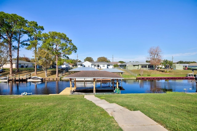 dock area featuring a lawn and a water view