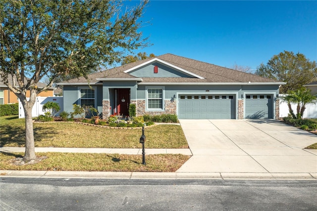 view of front facade with a garage and a front lawn