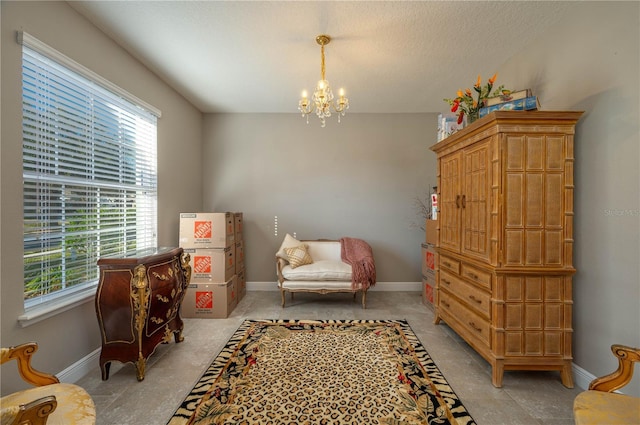 living area featuring a chandelier