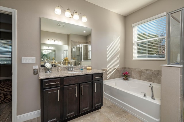 bathroom with tile patterned flooring, vanity, and separate shower and tub