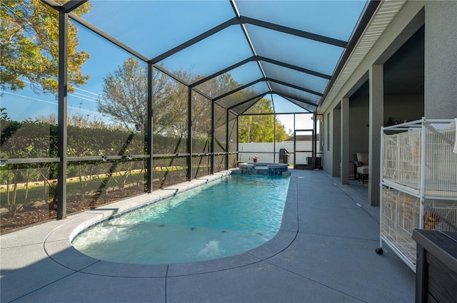 view of pool with an in ground hot tub, a lanai, and a patio