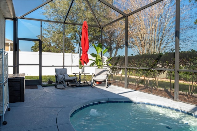 view of pool with a patio and glass enclosure