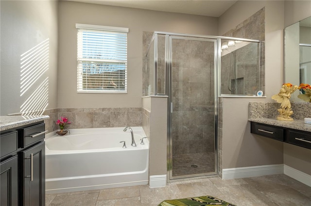 bathroom with vanity and separate shower and tub