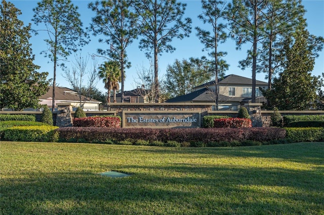 community sign featuring a lawn