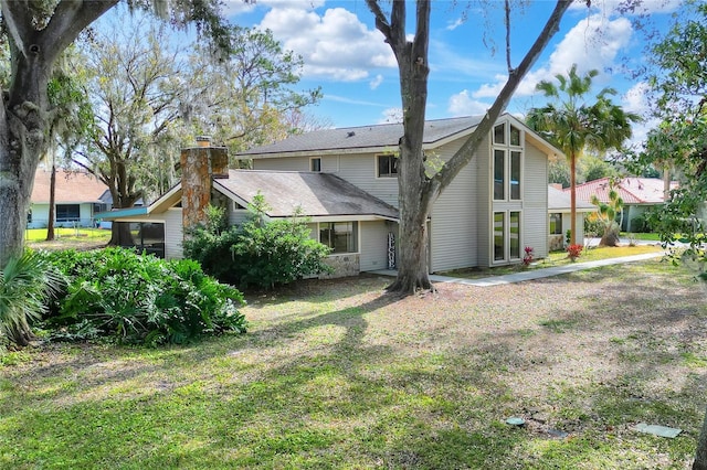 rear view of property featuring a yard