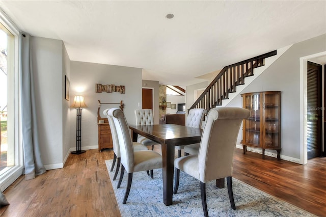 dining room with hardwood / wood-style flooring and a wealth of natural light