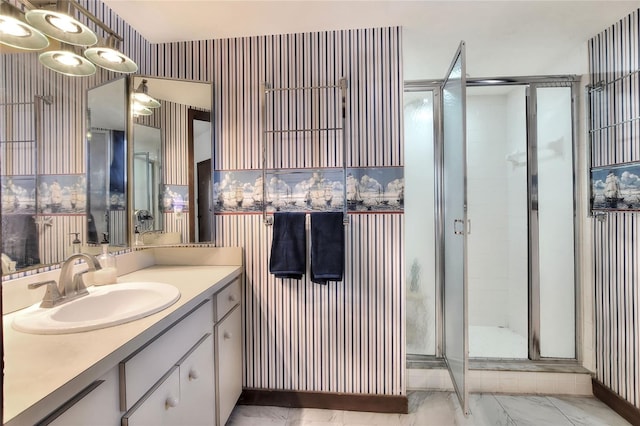 bathroom with vanity and a shower with door