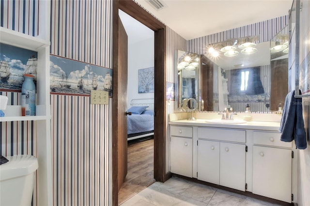 bathroom with toilet and vanity