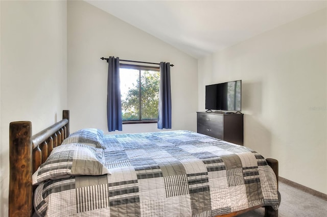 bedroom with vaulted ceiling and carpet flooring