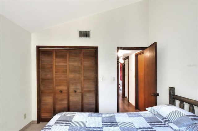 bedroom featuring a closet, vaulted ceiling, and carpet