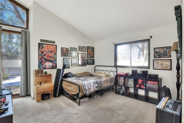 bedroom featuring high vaulted ceiling and light colored carpet