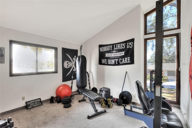 workout area featuring carpet floors, vaulted ceiling, and french doors