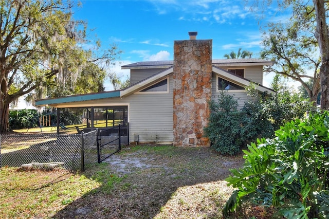 view of side of property with a carport