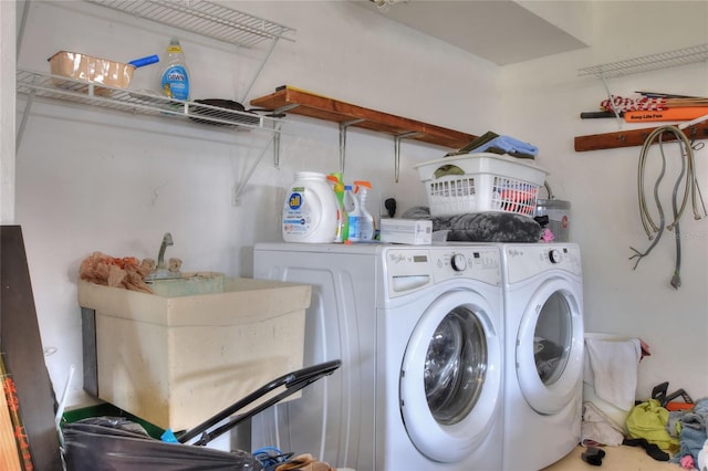 clothes washing area featuring sink and independent washer and dryer