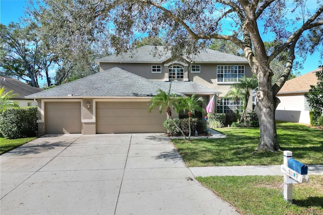 view of front of home with a garage and a front yard