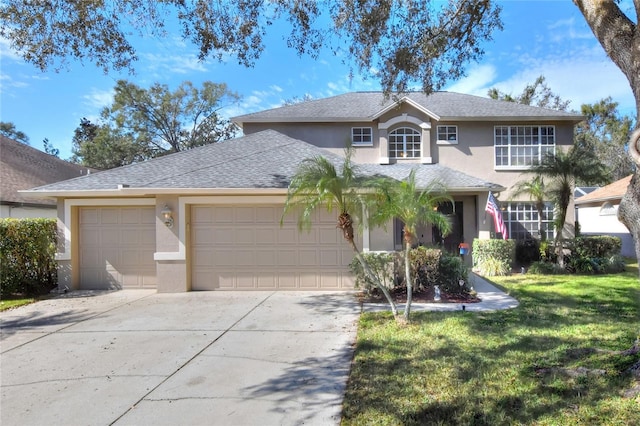 view of front of property featuring a garage and a front lawn