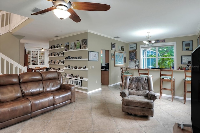 tiled living room featuring crown molding, ceiling fan with notable chandelier, and built in features