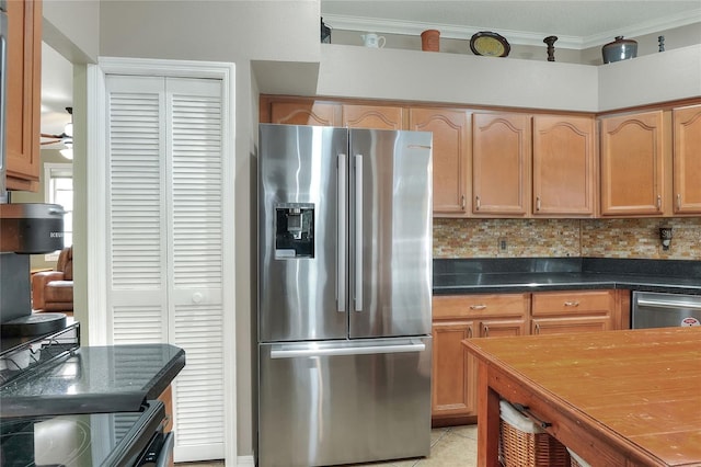 kitchen featuring crown molding, light tile patterned floors, appliances with stainless steel finishes, ceiling fan, and decorative backsplash