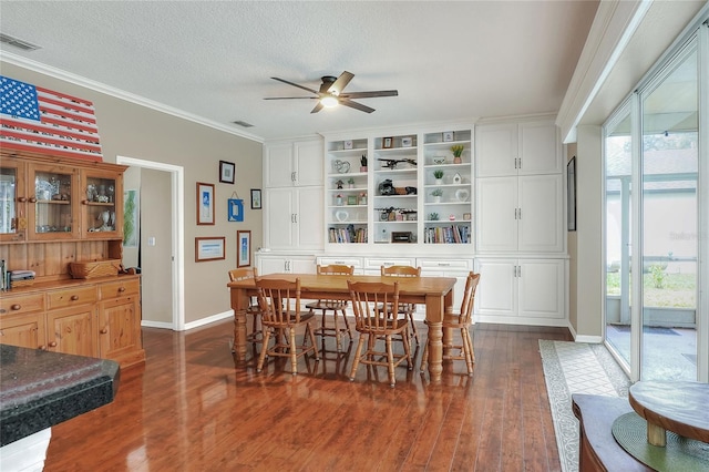 dining space featuring ceiling fan, ornamental molding, a textured ceiling, and dark hardwood / wood-style flooring