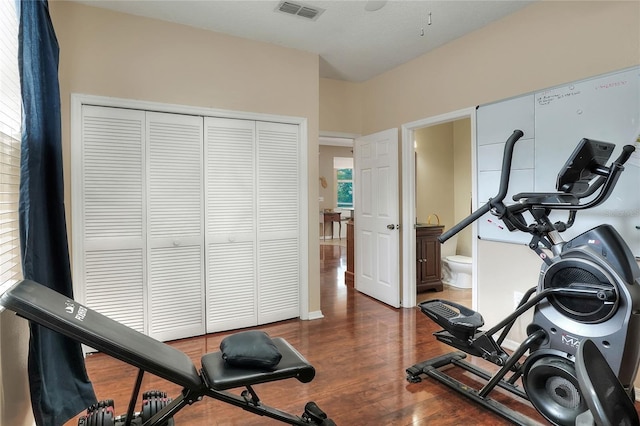 exercise room featuring dark wood-type flooring