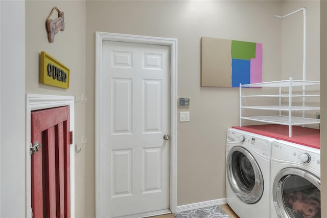 clothes washing area featuring separate washer and dryer