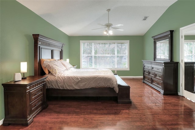 bedroom with ceiling fan, lofted ceiling, and dark hardwood / wood-style flooring