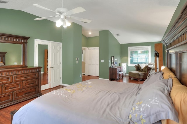 bedroom with vaulted ceiling, ceiling fan, and light wood-type flooring