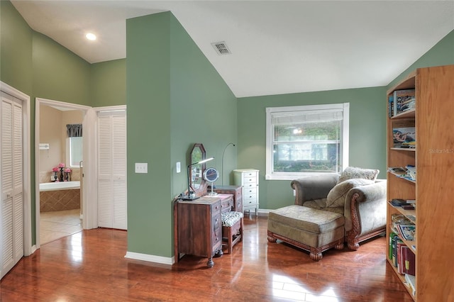 sitting room featuring hardwood / wood-style flooring and lofted ceiling