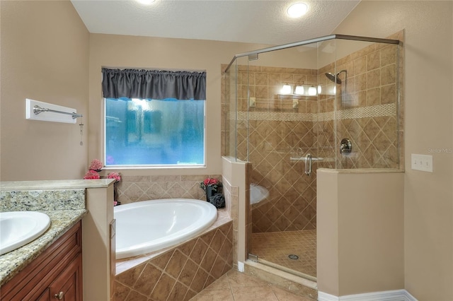 bathroom featuring vanity, a textured ceiling, tile patterned floors, and separate shower and tub