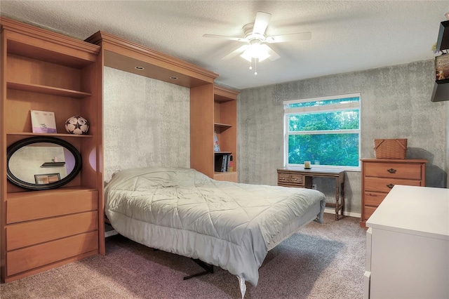 bedroom with ceiling fan, carpet flooring, and a textured ceiling