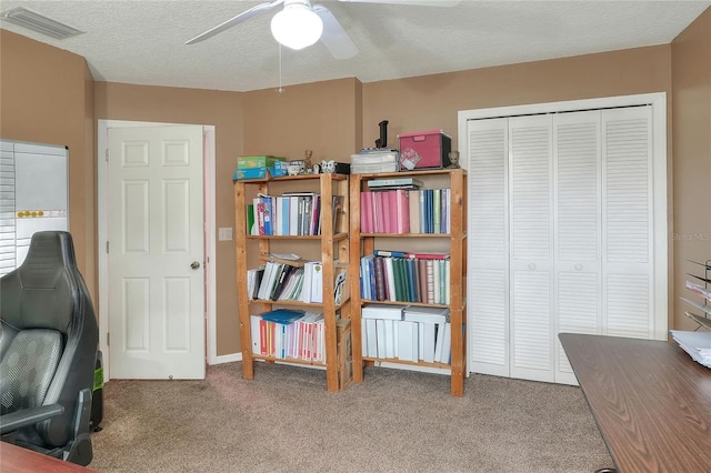 office featuring ceiling fan, carpet floors, and a textured ceiling