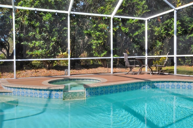 view of pool featuring an in ground hot tub and a lanai